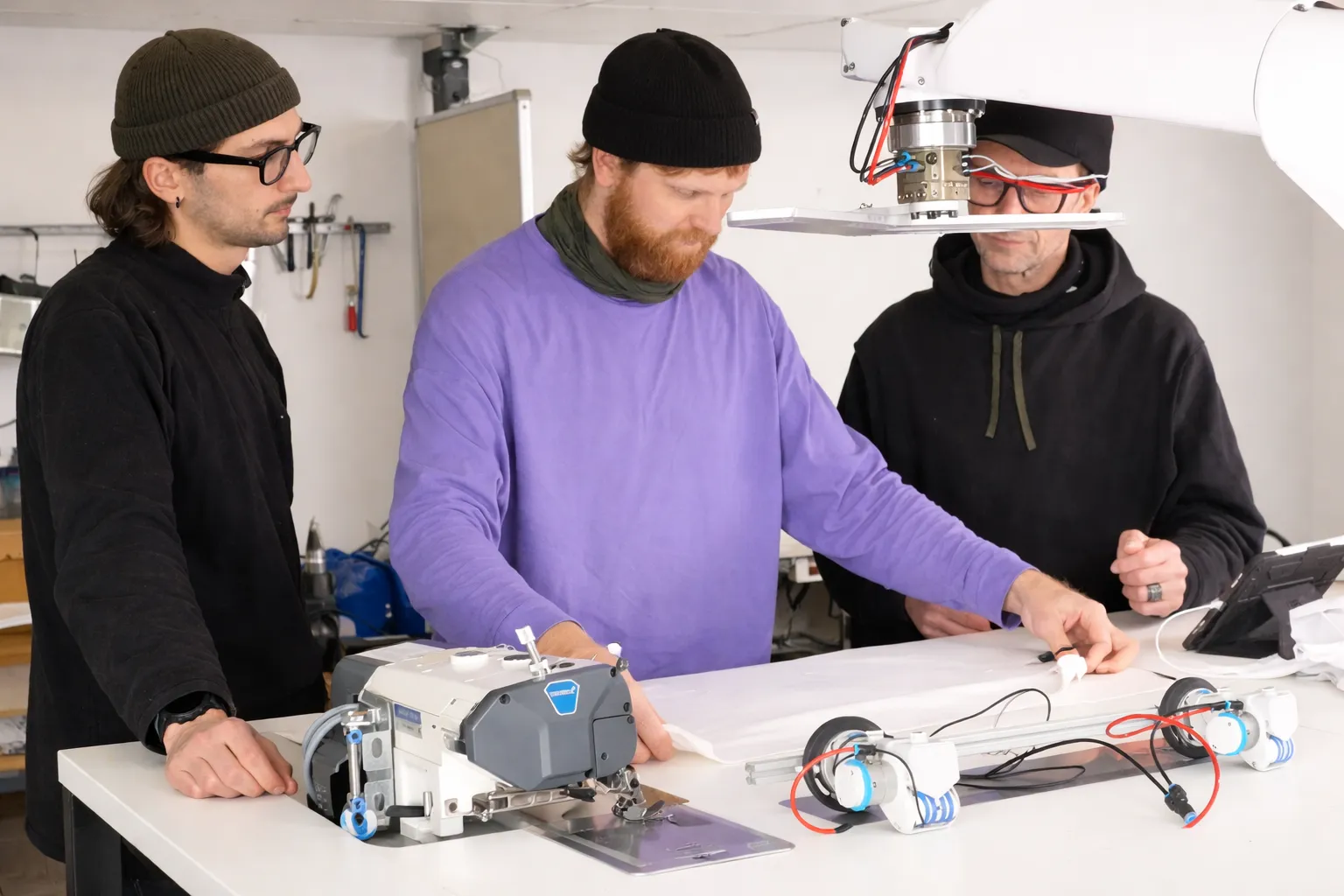 ADOTC team working on robotic textile automation in the workshop